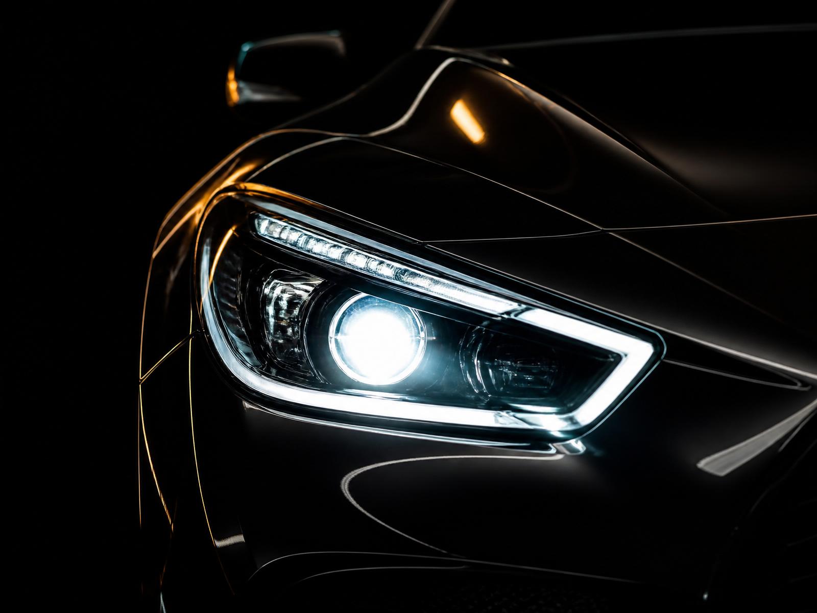 Crystal clear restored luxury car headlight glowing at night